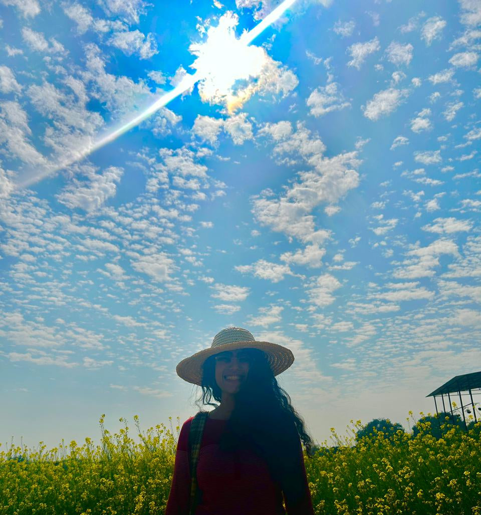 Girl in mustard field at Good Grown'd 